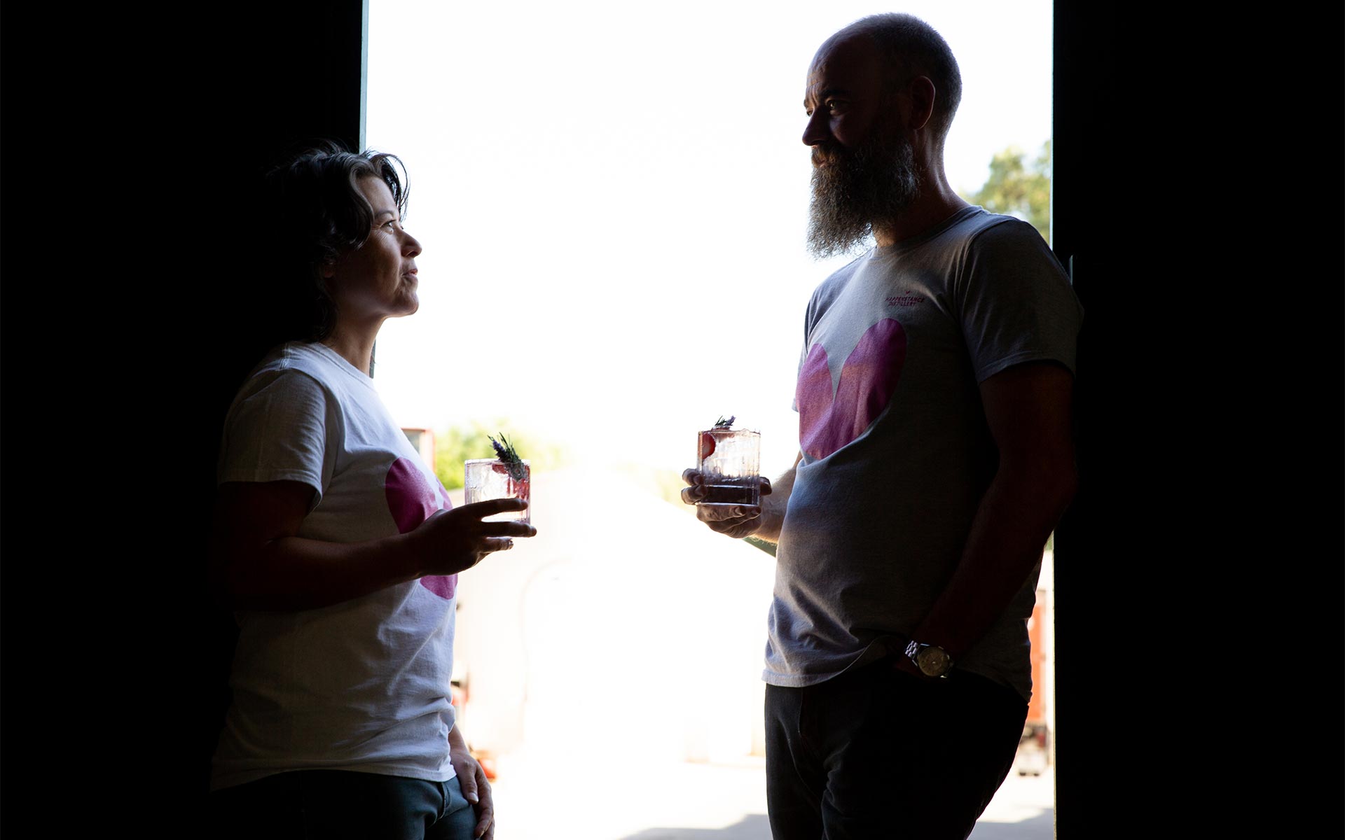 Happenstance Distillery - Mei-Lin and Tim in silhouette with drinks