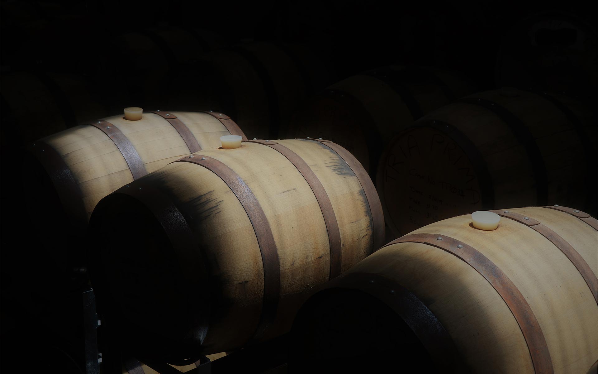 Tria Prima distillery - barrels in a dark warehouse