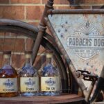 Robbers Dog Distillery - Bike sign and range of spirit bottles