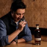 Woodwater – Distiller's Nose (male distiller enjoying the aroma of a glass of whisky)